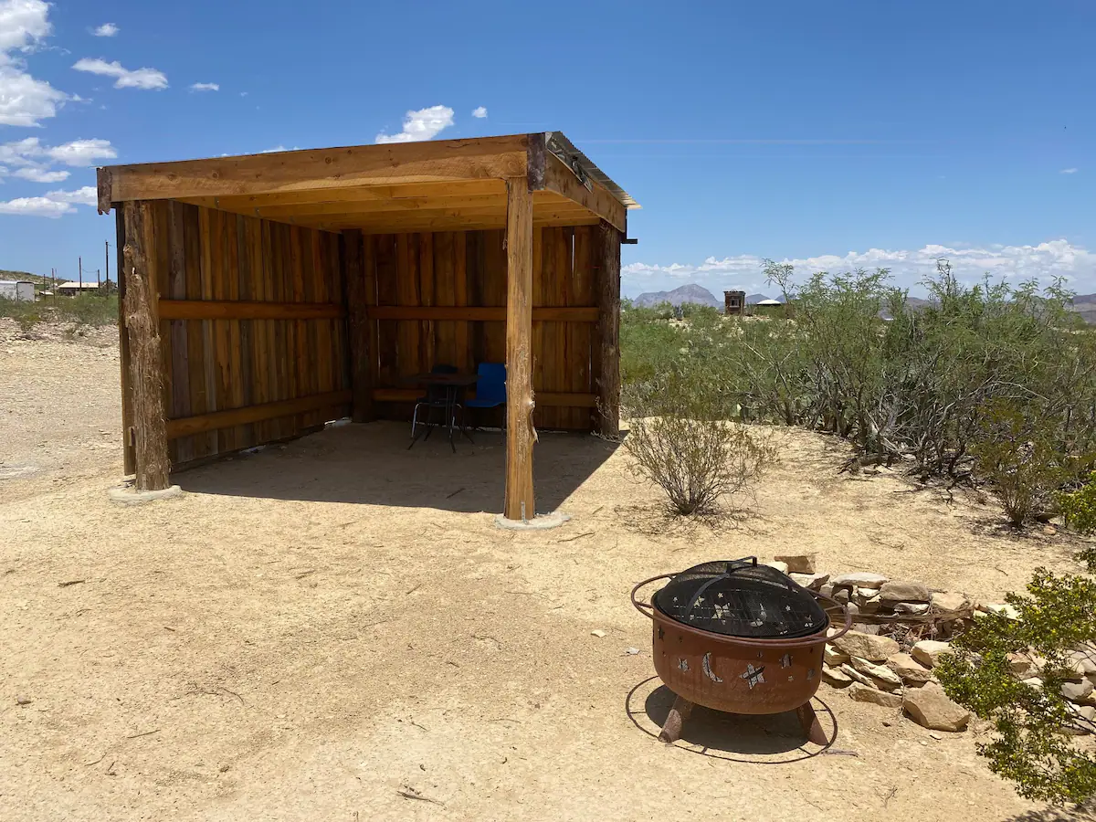 31fd2a63-2389-40be-8210-1bf91b16966c A fire pit in the middle of an open desert.