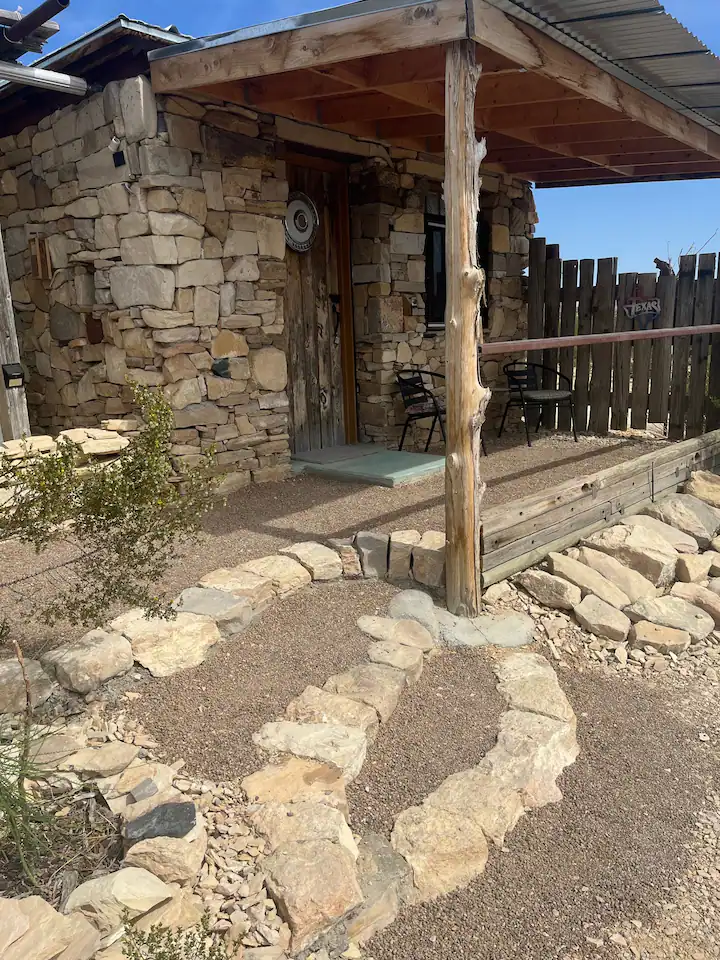 rrrradf A stone walkway leading to the entrance of a house.